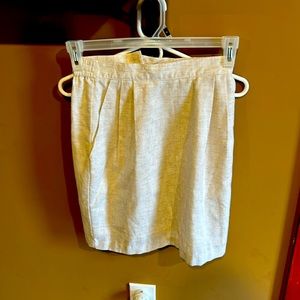 Off brand tweed cream and white skirt. Pleated in front. No signs of wear.